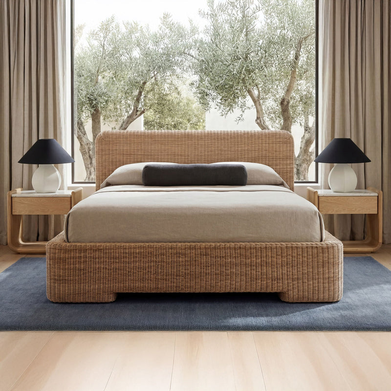Natural wood bedside table with open shelf, shown beside a bed