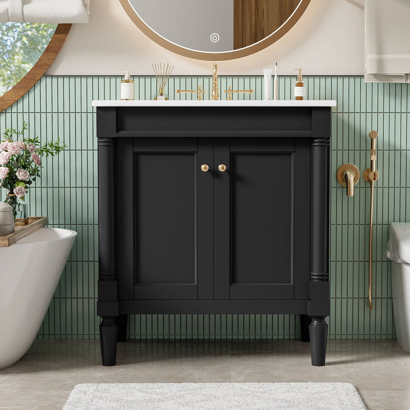 Black bathroom vanity cabinet with sink and two soft-close doors, gold knobs