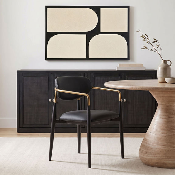 Black upholstered dining arm chair with rounded back, black legs, gold arm frame