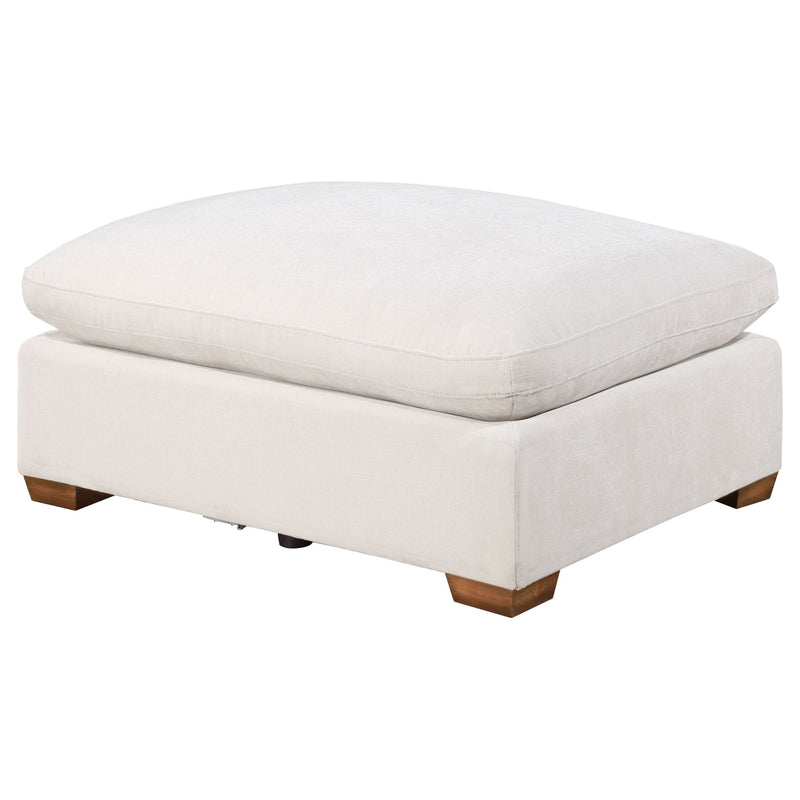 Beige upholstered ottoman with square base and padded hinged-style top.