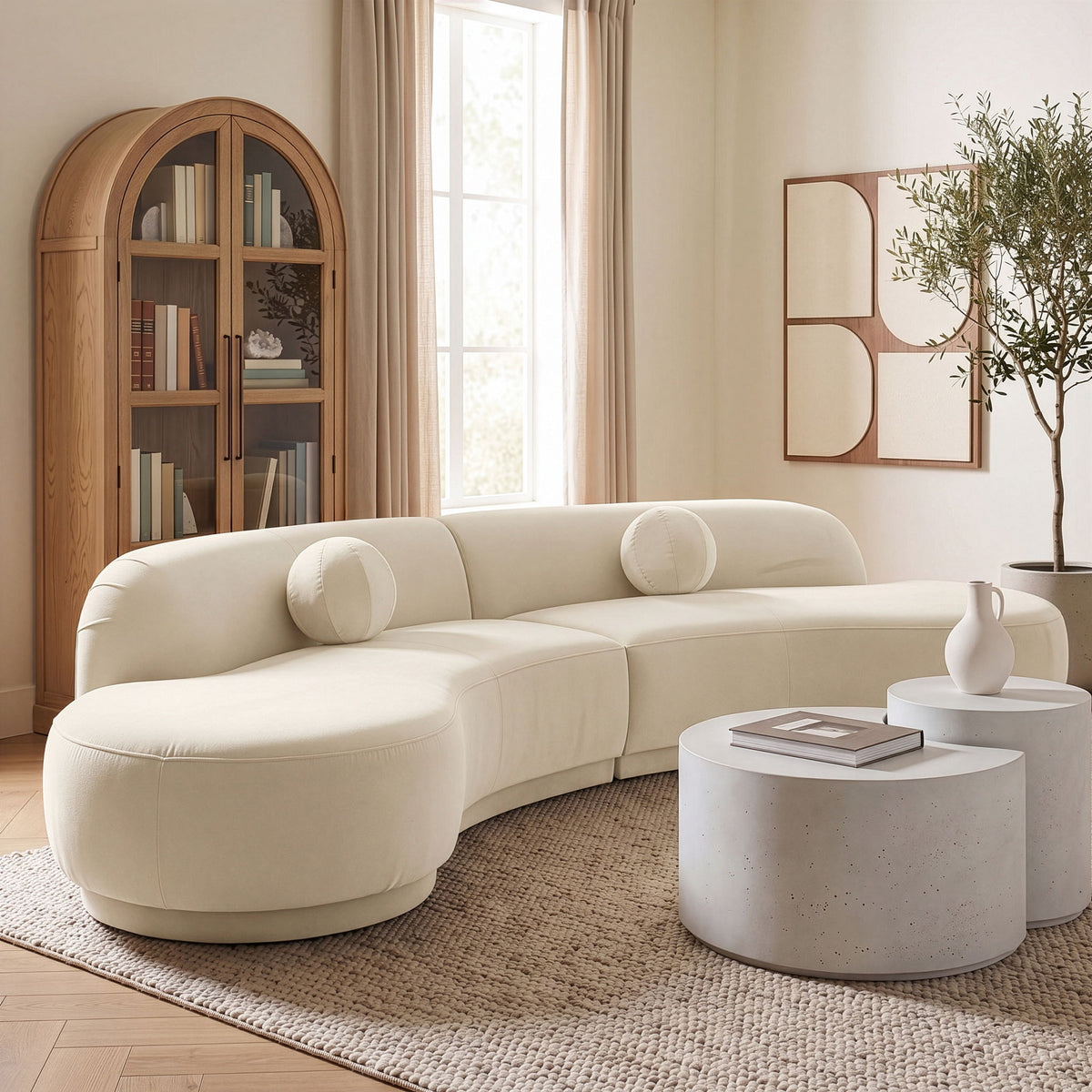 Beige velvet performance sectional sofa with rounded chaise and bolster pillows