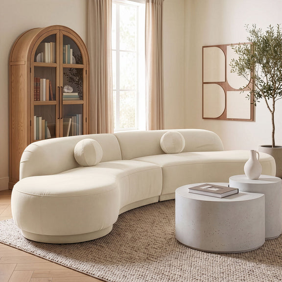 Beige velvet performance sectional sofa with rounded chaise and bolster pillows