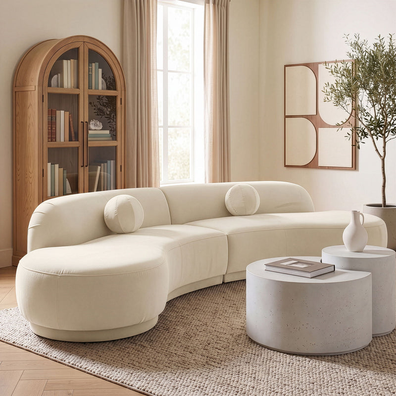 Beige velvet performance sectional sofa with rounded chaise and bolster pillows