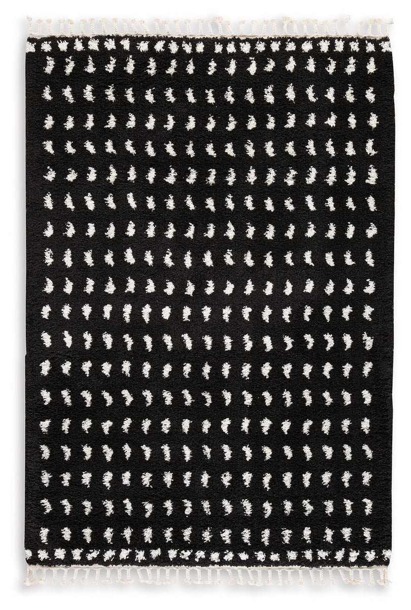 Black and white area rug with repeating abstract pattern and fringe edges