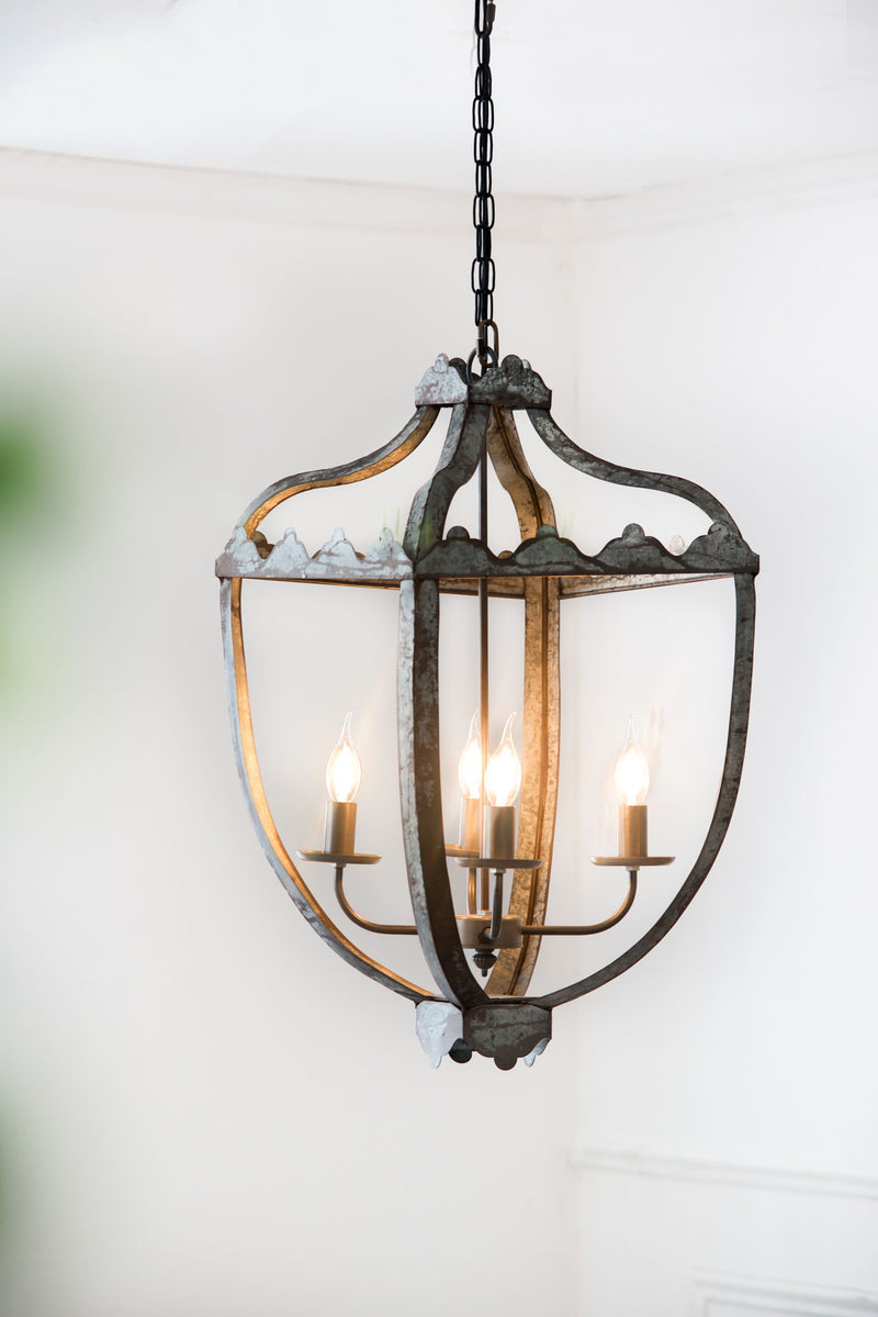 Gray 4-light hanging chandelier with clear glass panels and curved metal frame, candle-style bulbs.