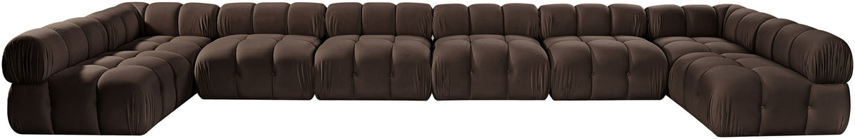 Dark brown modular sectional sofa with tufted, padded cushions and curved arm