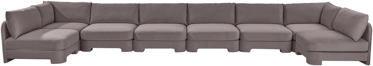 Dark gray velvet armless sectional sofa with low back and padded seat cushions