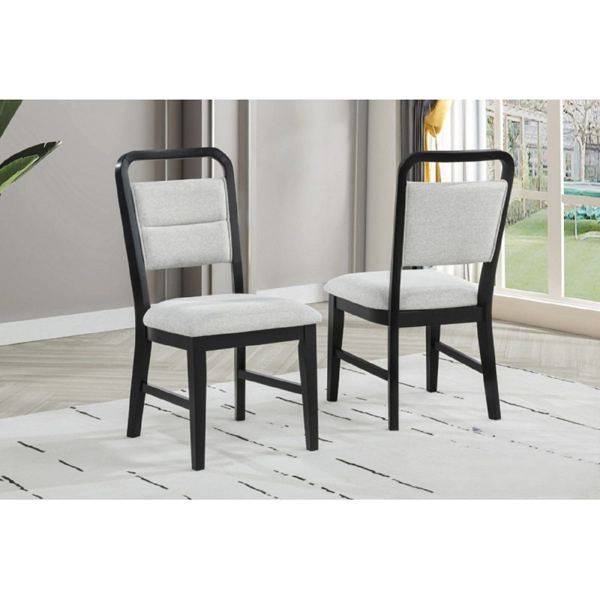 Pair of dining side chairs with curved black backs and light gray upholstered cushions