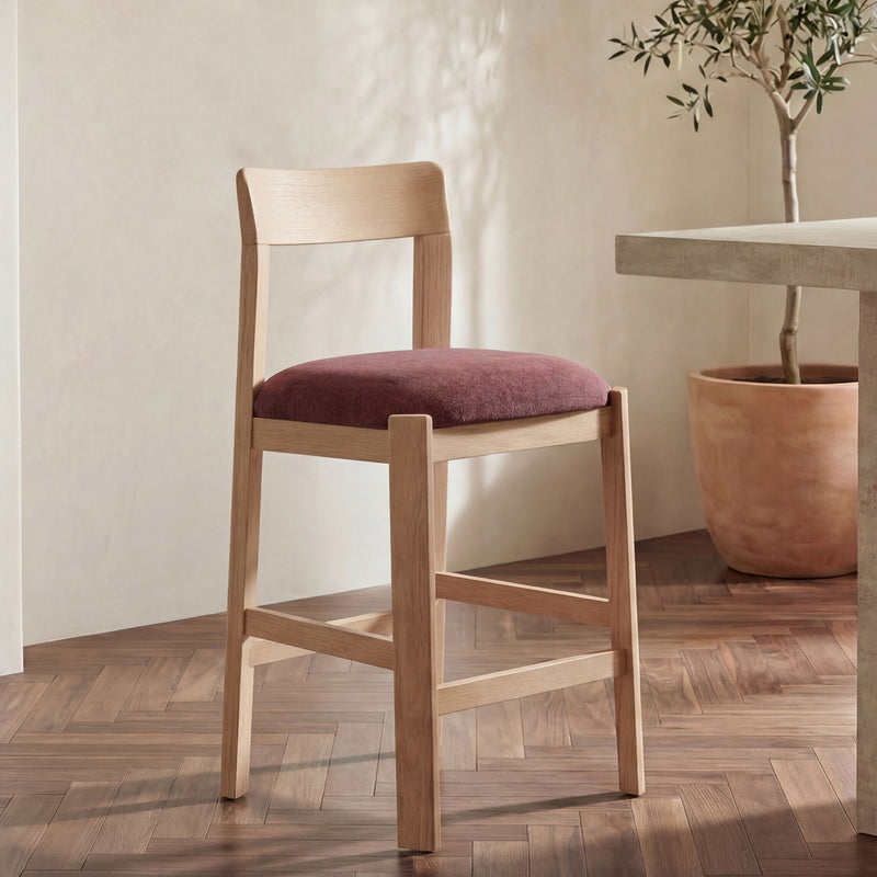 Light wood counter stool with curved backrest and burgundy seat cushion