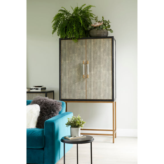 Gray bar cabinet with two concrete-textured doors, brass-toned pulls, and wooden base