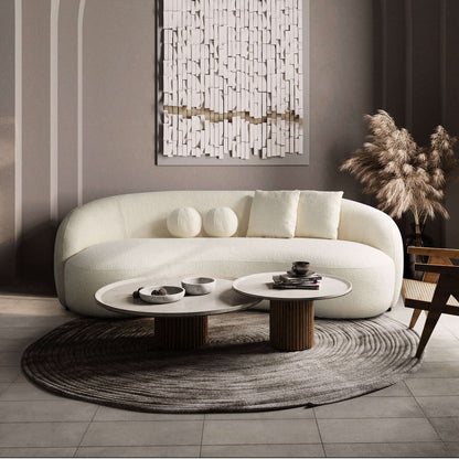 Boucle curvy sofa in light off-white with two back cushions and two round accent cushions