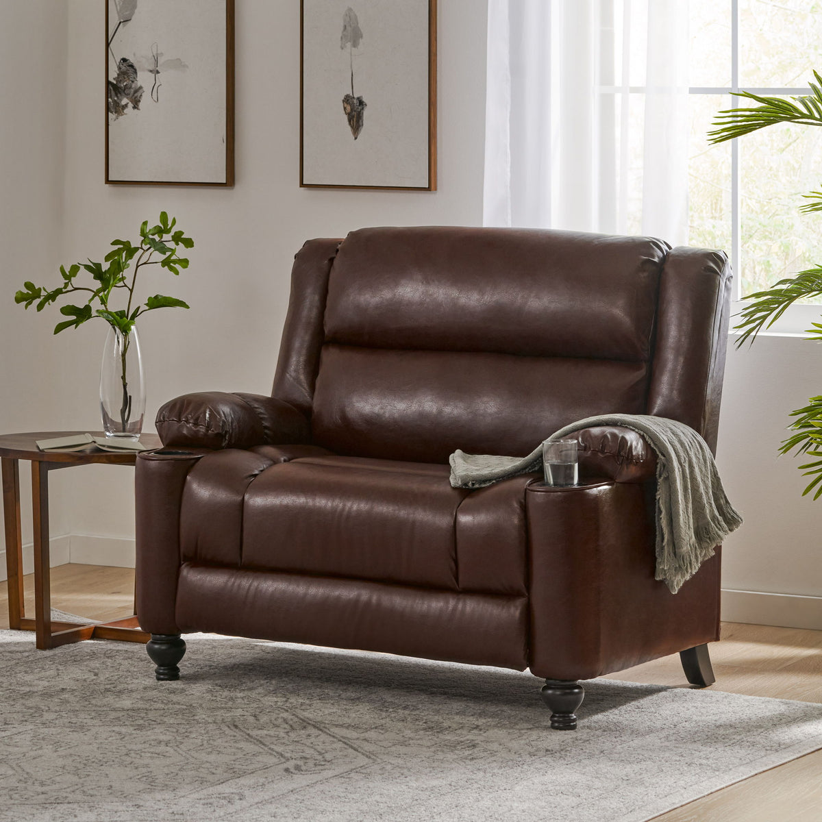 Dark brown manual recliner chair with padded arms, recline back, and knob feet