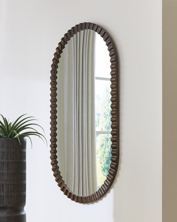 Oval wall mirror with ribbed dark brown frame and vertical reflection