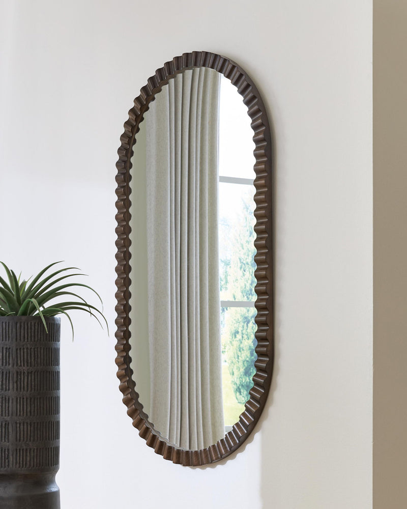 Oval wall mirror with ribbed dark brown frame and vertical reflection