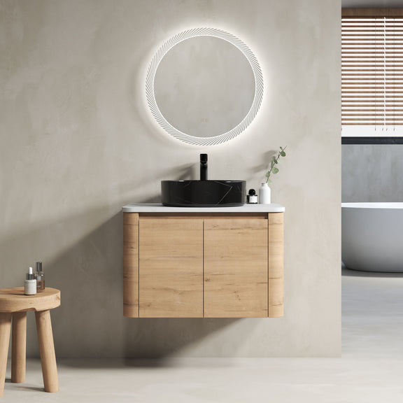 Wall-mounted bathroom vanity with light-wood cabinet and black art sink, round mirror