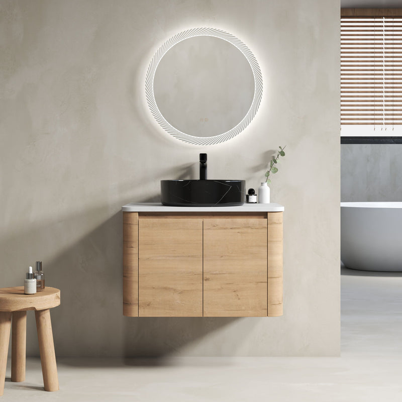 Wall-mounted bathroom vanity with light-wood cabinet and black art sink, round mirror