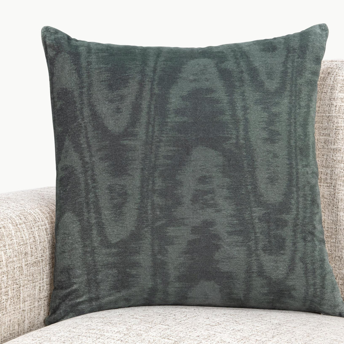 Dark green patterned 22 x 22 inch pillow on light sofa