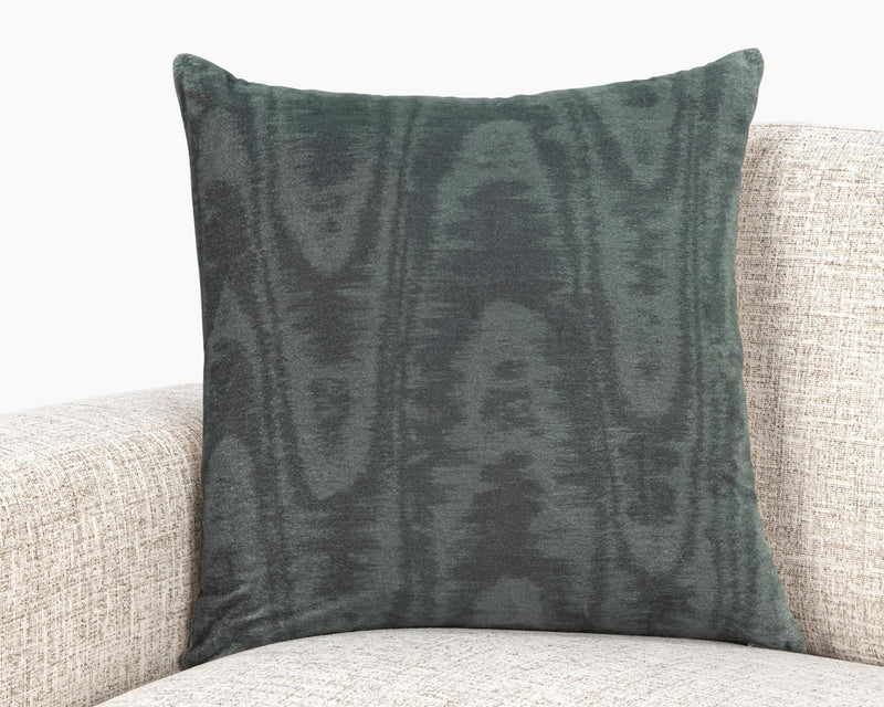 Dark green patterned 22 x 22 inch pillow on light sofa