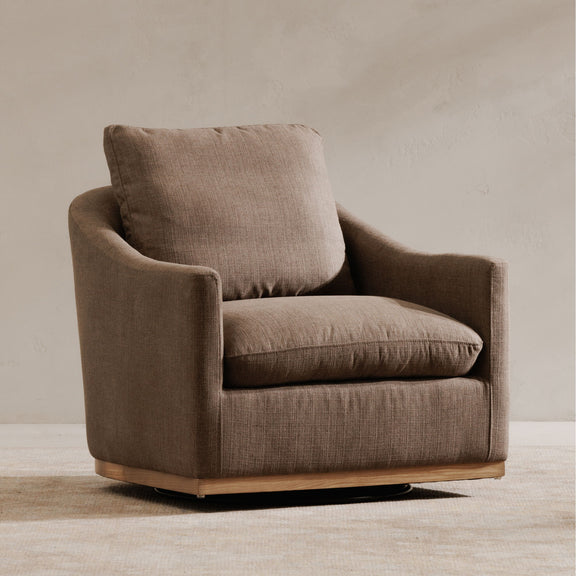 Soft taupe fabric swivel chair, side view with deep seat and wide arms