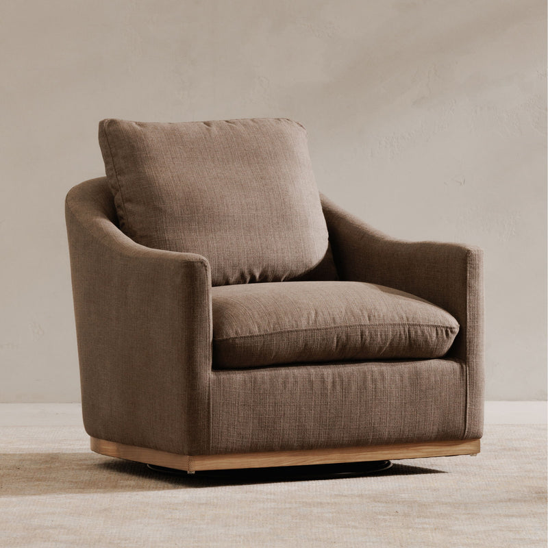 Soft taupe fabric swivel chair, side view with deep seat and wide arms