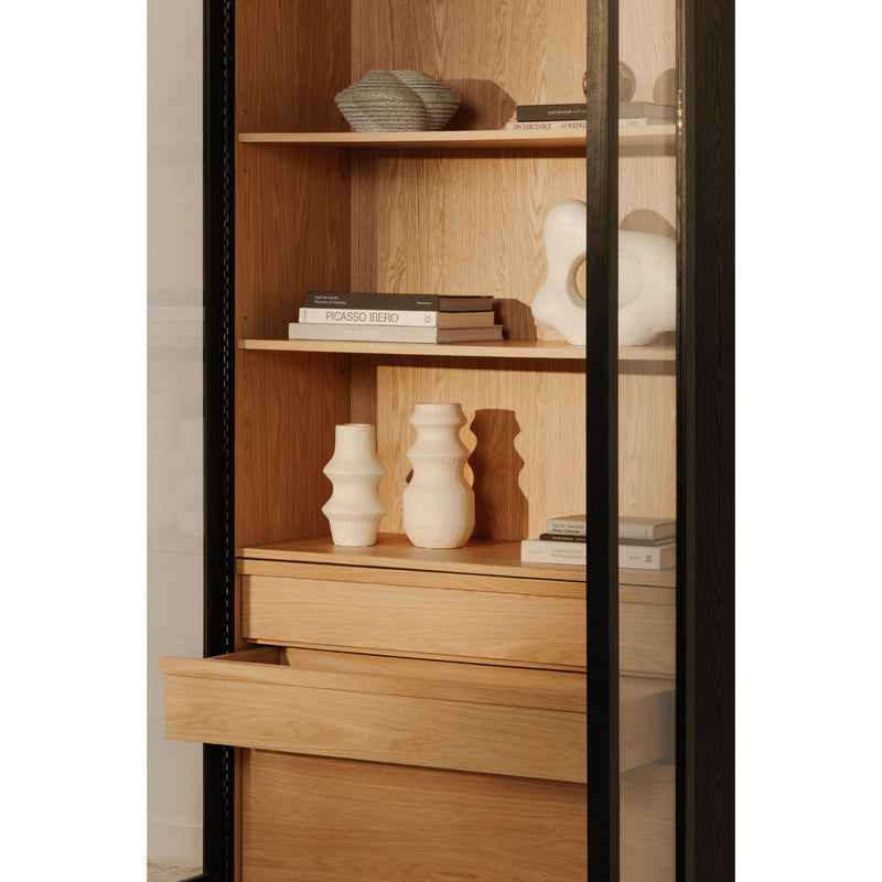 Tall cabinet interior with wood shelves and drawers behind glass, black frame