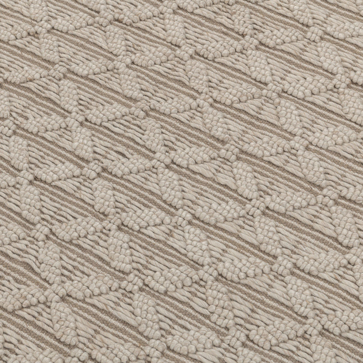 Beige textured rug surface with raised looped pattern and geometric stripes.