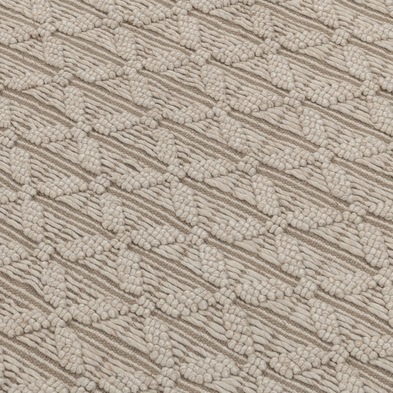Beige textured rug surface with raised looped pattern and geometric stripes.