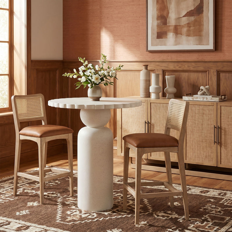 Indoor/outdoor table with round white top and light wood pedestal base