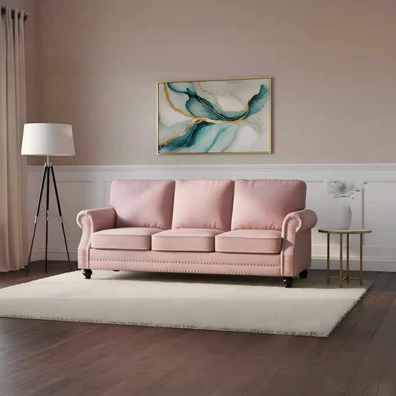 Blush pink 3-seat sofa with nailhead trim and turned legs, in living room