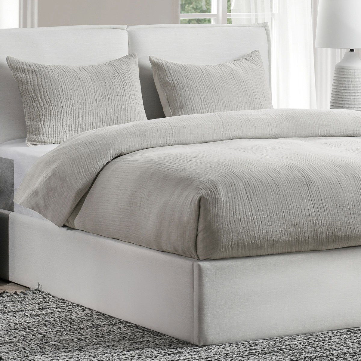 Gray textured duvet cover and pillows on a bed