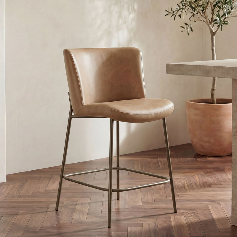 Tan leather counter stool with wide seat, curved backrest, metal frame