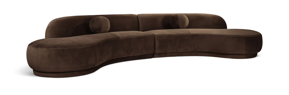 Dark brown velvet sectional sofa with tufted cushions and curved chaise profile