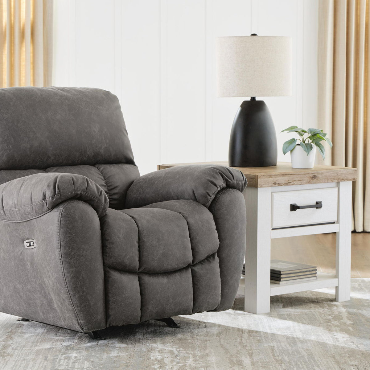 Power rocker recliner with adjustable headrest, dark gray fabric, plush back and padded armrests