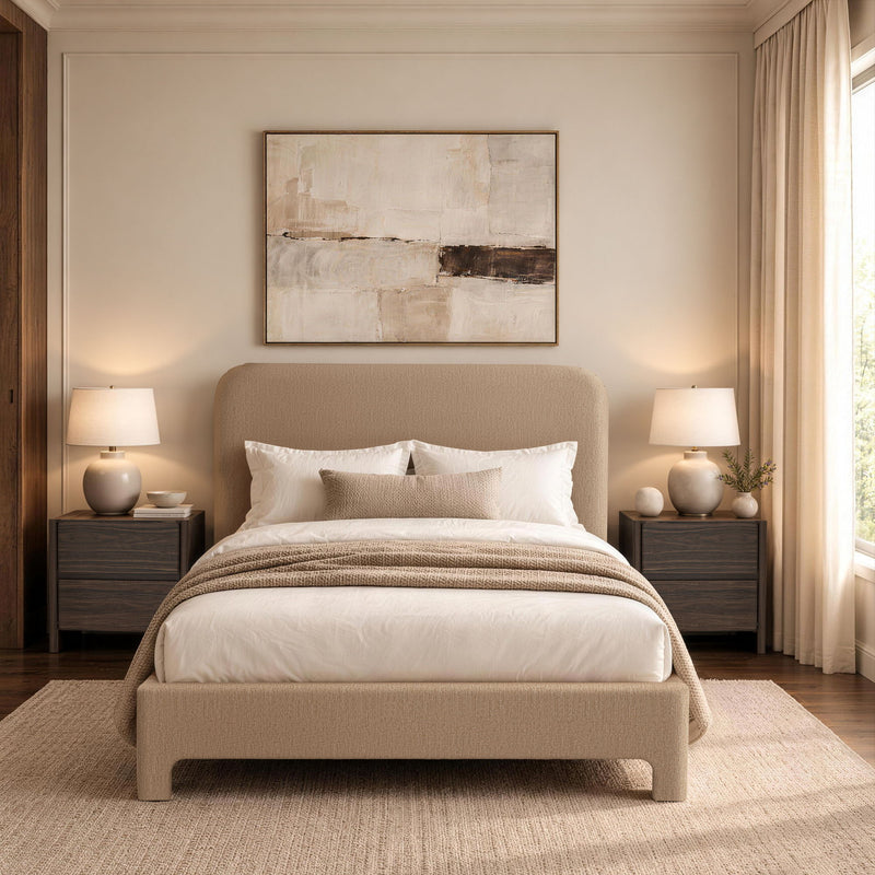 Light brown upholstered bed with rounded headboard, white duvet, pillows, and striped throw