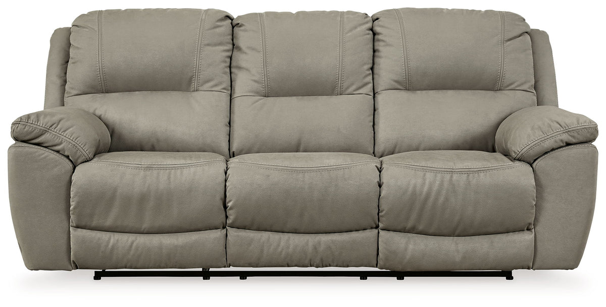 Putty gray reclining sofa with three padded seats and rolled armrests