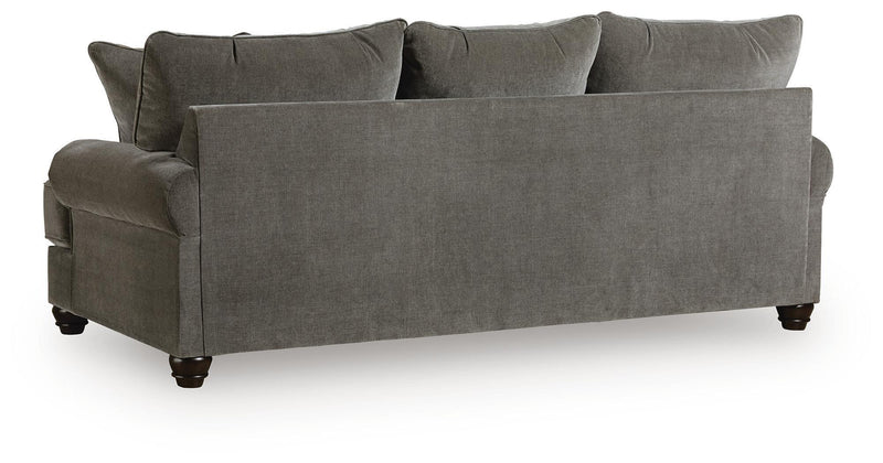 Dark gray fabric sofa with low rolled arms, wide seat cushions, and three back pillows