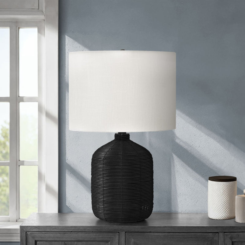 Modern table lamp with black rattan base and white fabric drum shade