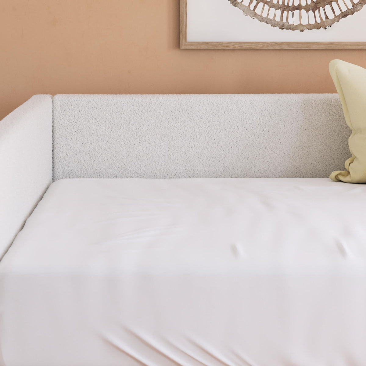 Beige upholstered day bed backrest and seat with white mattress and side pillow