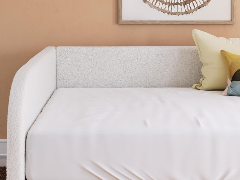 Beige upholstered day bed backrest and seat with white mattress and side pillow