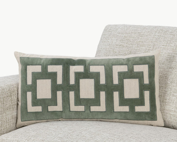 Light beige pillow with green geometric applique on a rectangular front