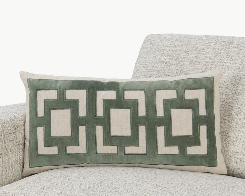Light beige pillow with green geometric applique on a rectangular front