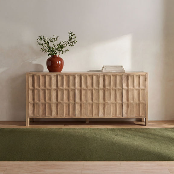 Natural wood sideboard with six paneled doors and a styled top surface