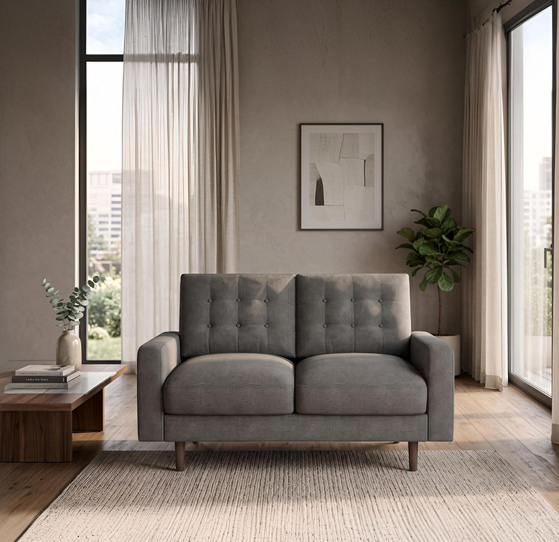 Dark gray two-seat loveseat sofa with tufted back cushions and wooden legs