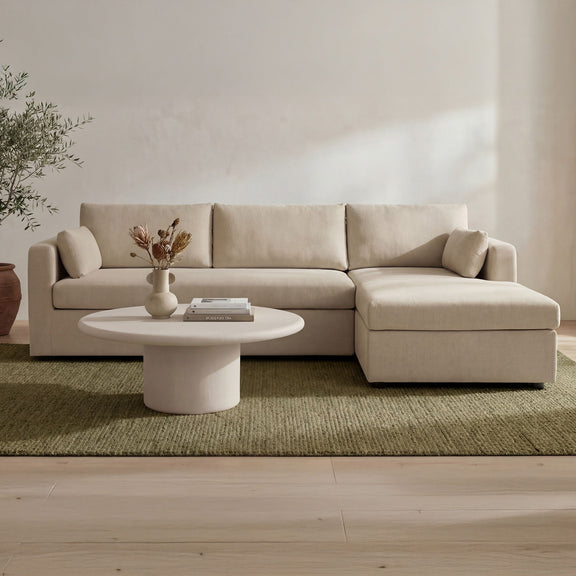 Sand sectional sofa with right chaise and roomy seat cushions in a living room