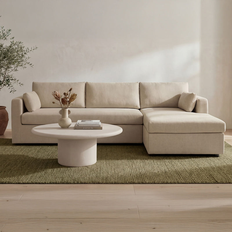 Sand sectional sofa with right chaise and roomy seat cushions in a living room