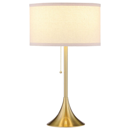 Beige drum shade table lamp with gold-tone base and pull-chain switch
