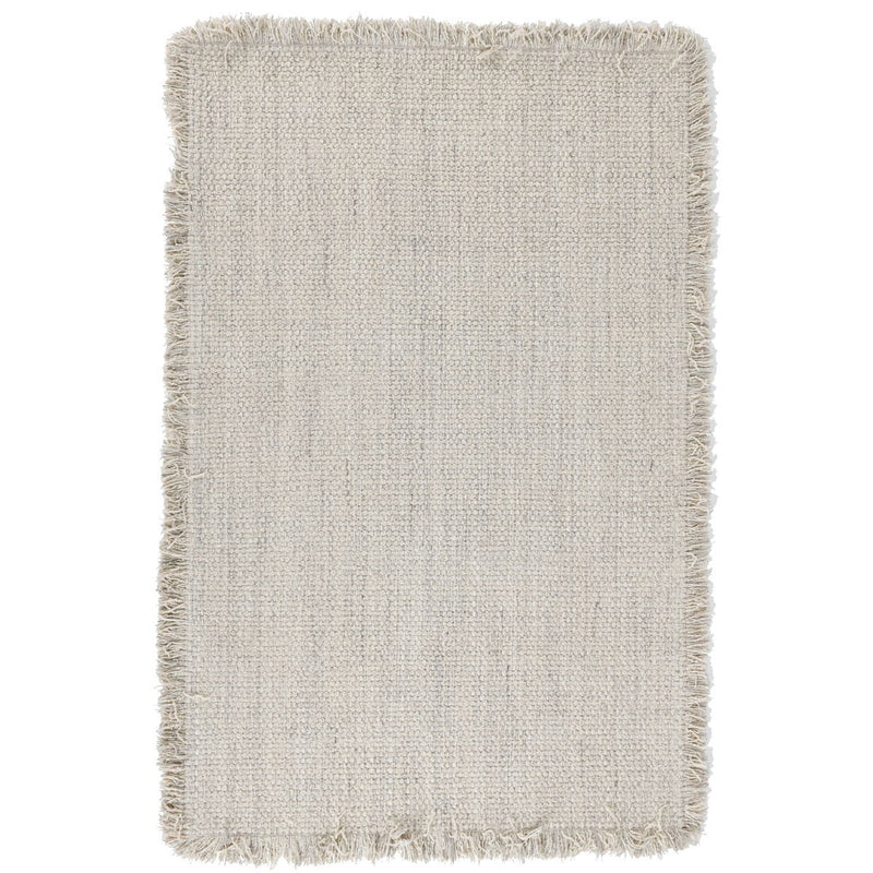 Ivory wool rug with short fringed edges and subtle woven texture.