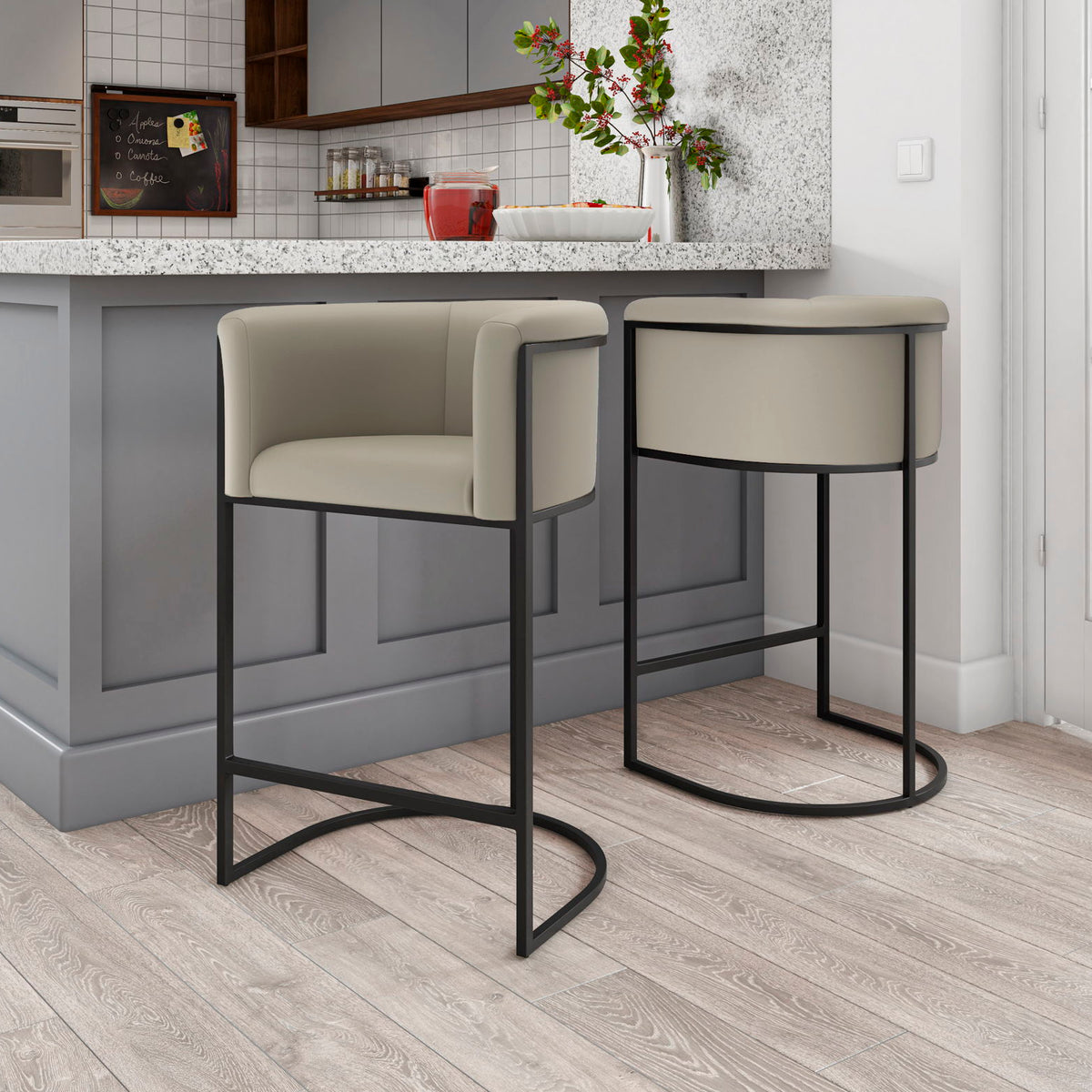 Set of two light beige upholstered counter stools with curved black base frames