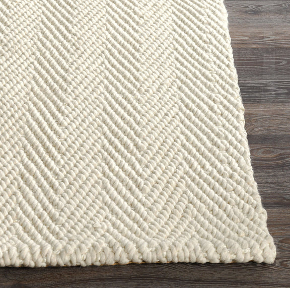 Cream herringbone chenille rug corner with looped zigzag texture
