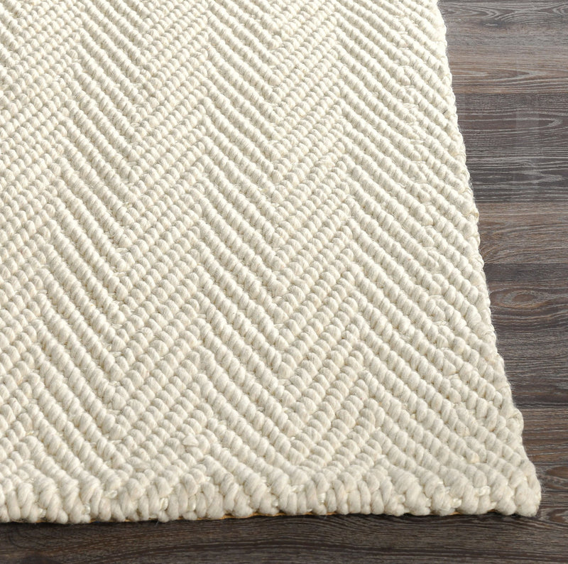 Cream herringbone chenille rug corner with looped zigzag texture